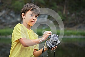 Boy is washing digital camera with foam