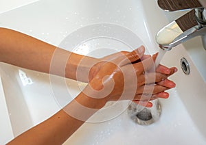 A boy Washing hands with soap children hand for coronavirus prevention and to stop spreading coronavirus photo