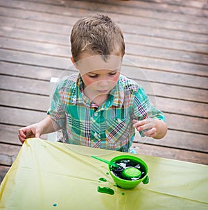 Boy Watches His Easter Egg in the Green Dye