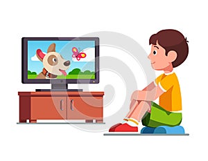 Boy watching film on TV about dog and butterfly