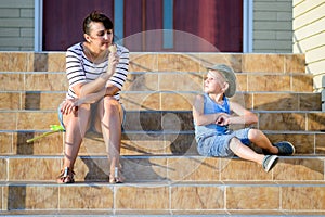 Boy Watching Mother Eat Ice Cream Cone on Steps