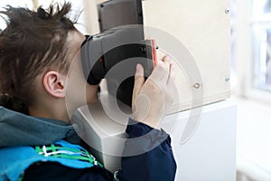 Boy watching slides in stereoscope