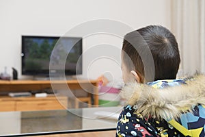 Chinese kid watching cartoon TV