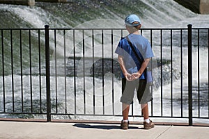 Boy Watching Water at Dam