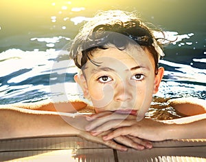 Boy in water galsses close up portrait in swimming pool