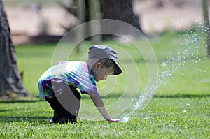 Boy at water sprinkler