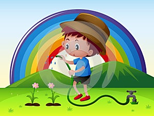 Boy watering flowers in garden