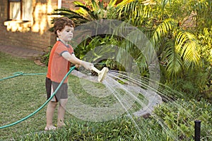 Boy watering the garden