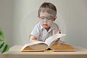 boy wearing glasses reading a book, book lover concept, learn to read