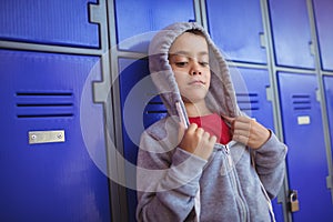 Boy wearing hooded shirt by lockers