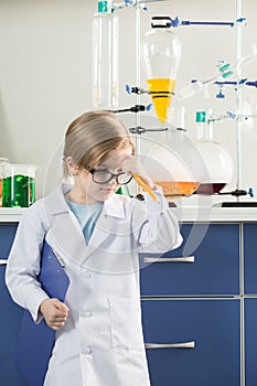 Boy wearing lab coat in science laboratory