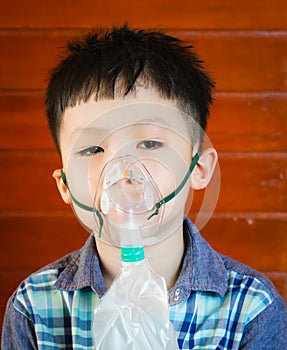 Boy wearing oxygen mask.