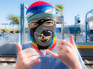 Boy Wearing Peru Waq'ollo Wool Knit Mask At Train Station In Santa Monica