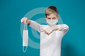 Boy wearing protection mask pointing on mask