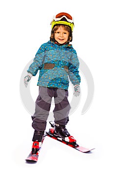 Boy wearing skies stands on white background