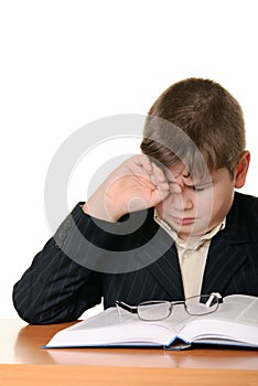 Boy wearing spectacles masses an eye for weariness