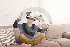 Boy wearing virtual reality glasses watching movies