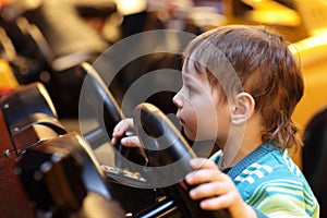 Boy at the wheel of car simulator
