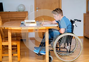 Boy in wheelchair doing homework