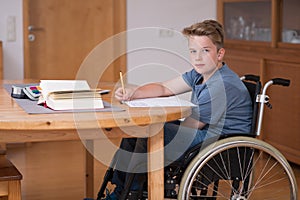 Boy in wheelchair doing homework
