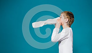 Boy in white clothes blowing his nose