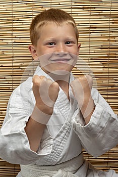 Boy in a white kimono in a fighting stance