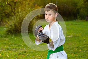 Boy in white kimono during training karate