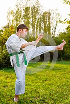Boy in white kimono during training karate