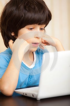 Boy with white notebook, online education