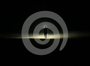 A boy who stand in beach in the Darkest night photo