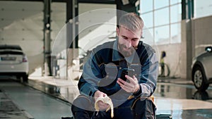 Boy who works at an indoor car wash who took a break to eat a banana. Commercial video.