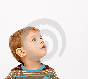 Boy in winter clothes looking up