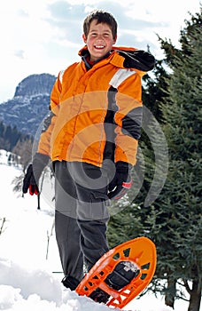 Boy with winter clothing and snowshoes