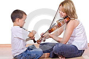 Boy and woman practicing the violin