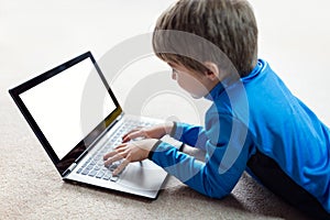 Boy working on laptop computer
