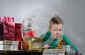 Boy wrapping up christmas gifts