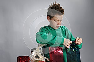 Boy wrapping up christmas gifts