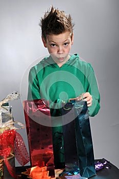 Boy wrapping up christmas gifts