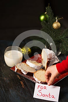 A boy writes a note to Santa and prepares a treat