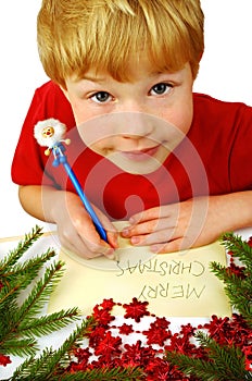 Boy writing Christmas wishes