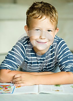 Boy is writing on his copybook