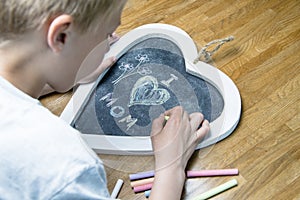 Boy writing I love mom