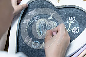 Boy writing I love mom