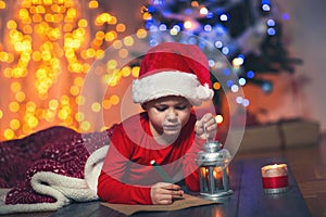 Boy writing letter to Santa Claus