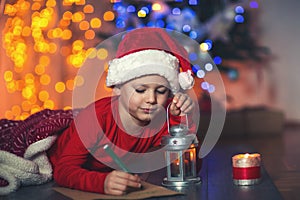 Boy writing letter to Santa Claus