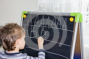 Boy writing letters learning procces son smart child