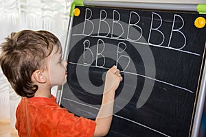 Boy writing letters learning procces son smart child