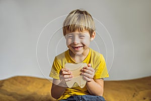 A boy, 6 years old, holds a box for milk teeth. Change of teeth