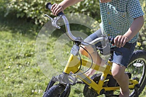 Boy on a yellow bicycles.