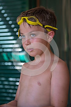 Boy with Yellow Pool Goggles Ready to Swim: Summertime Concept
